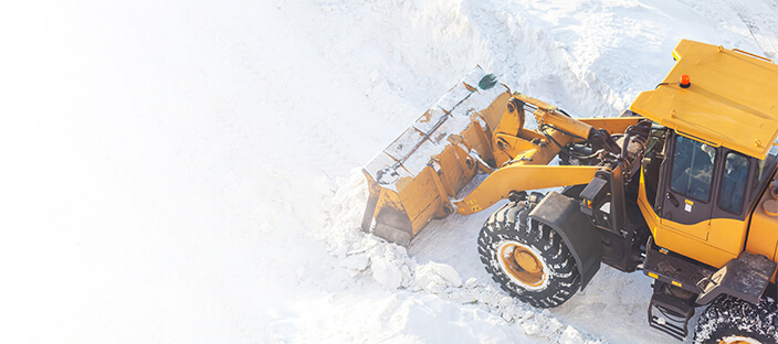 Front end loader moving snow